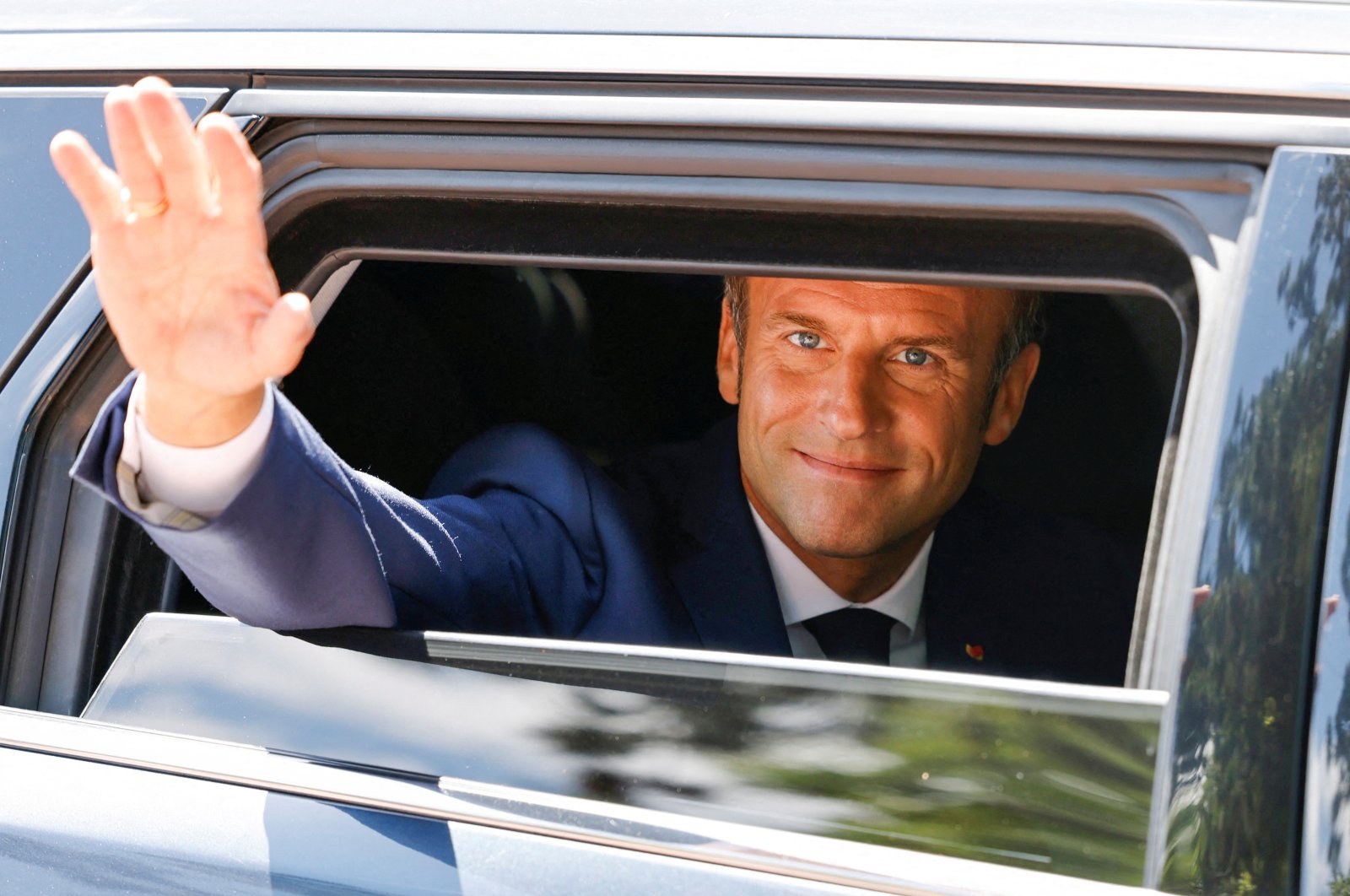 French President Emmanuel Macron waves as he votes in the first round of French parliamentary elections, at a polling station in Le Touquet, France, June 12, 2022. (Reuters Photo)