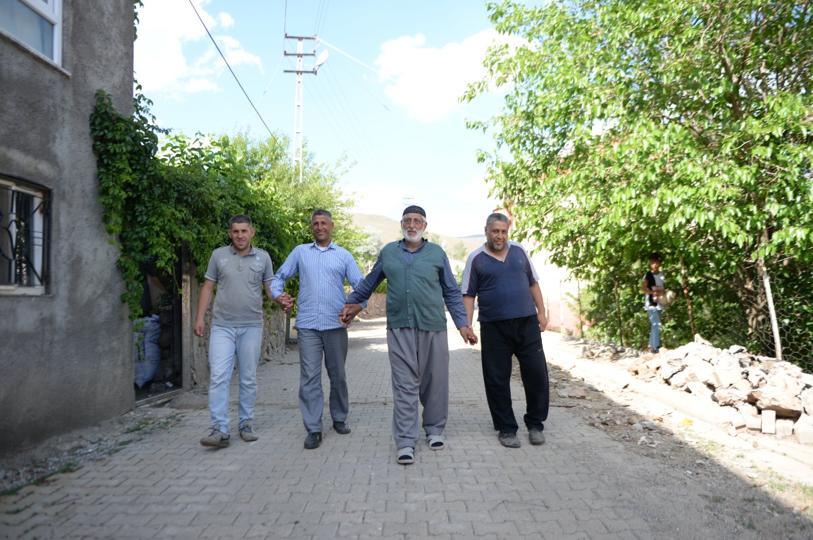 Şefik Ayceman (2nd R) walks with his sons, in Bingöl, eastern Turkey, June 18, 2022. (AA Photo)