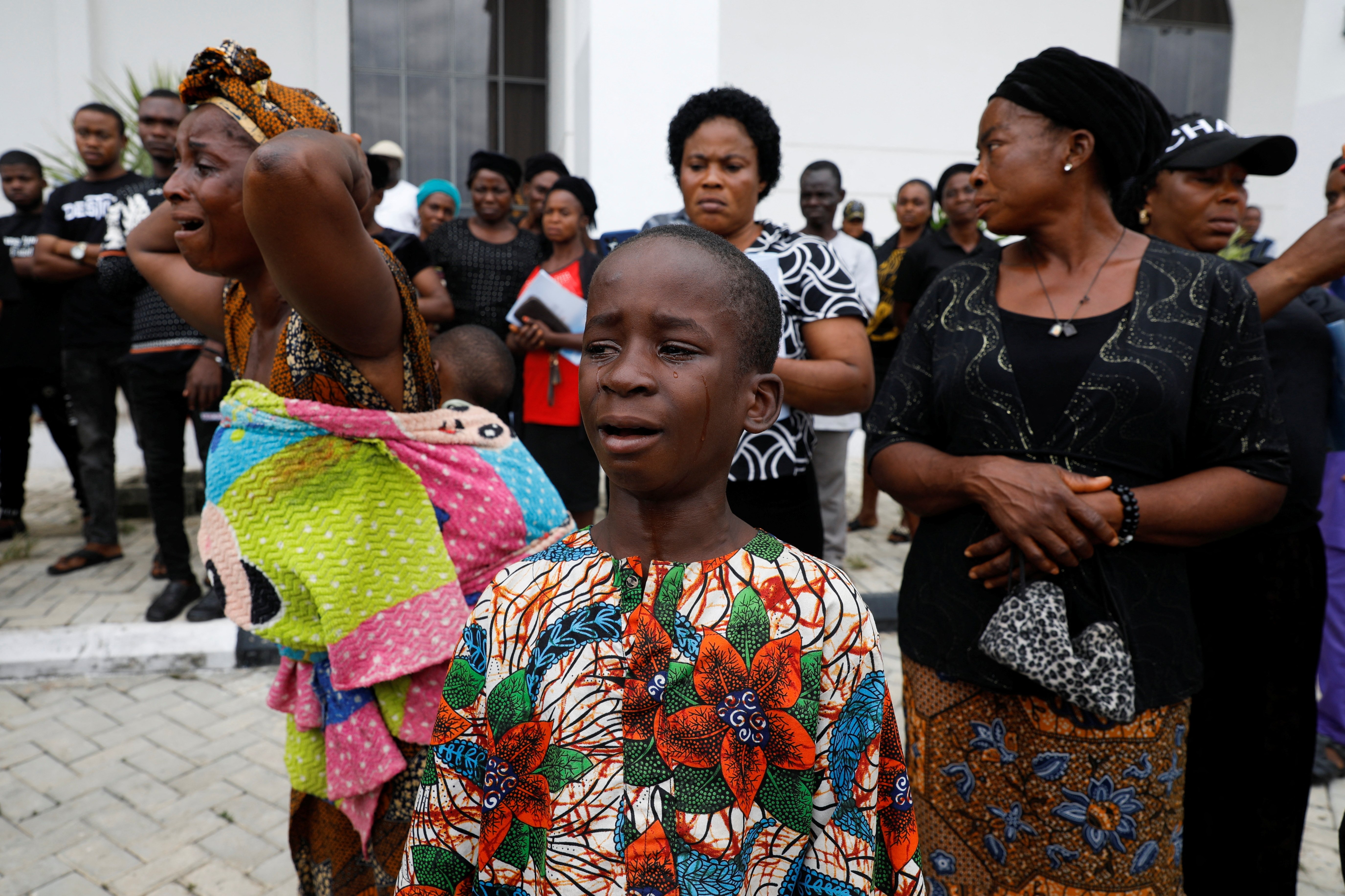 People grieve after a mass memorial service for victims killed in an attack by gunmen during a Sunday mass service at St. Francis Catholic Church in Owo, Ondo, Nigeria, June 17, 2022. (REUTERS PHOTO)
