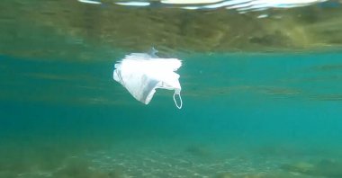 A mask floats under the water off the coast of Trabzon, northern Turkey, June 20, 2022. (DHA Photo)