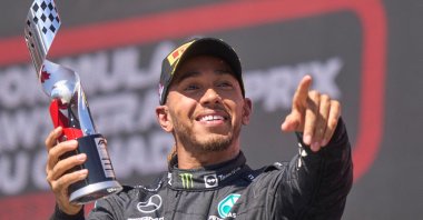 Mercedes' British driver Lewis Hamilton celebrates on the podium after placing third at the Canada Formula 1 Grand Prix, Montreal, Canada, June 19, 2022. (AFP Photo)