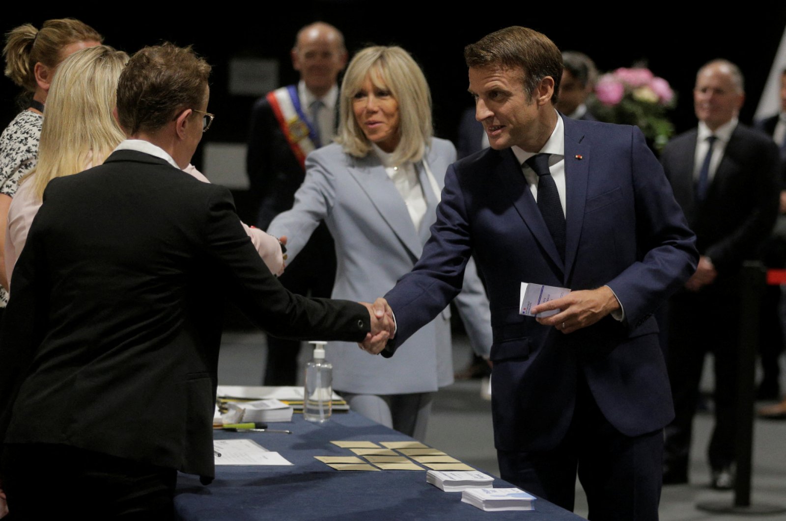 French President Emmanuel Macron and his wife Brigitte Macron arrive to vote during the final round of the country&#039;s parliamentary elections, Le Touquet, France June 19, 2022. (Reuters Photo)