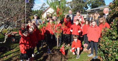 Students pose next to a tree they planted at Scotsburn primary school, in Victoria, Australia, June 20, 2022. (AA PHOTO)