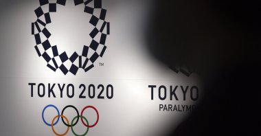 A person walks near Tokyo 2020 logo in Haneda Airport, Tokyo, Japan, June 14, 2021. (AP Photo)