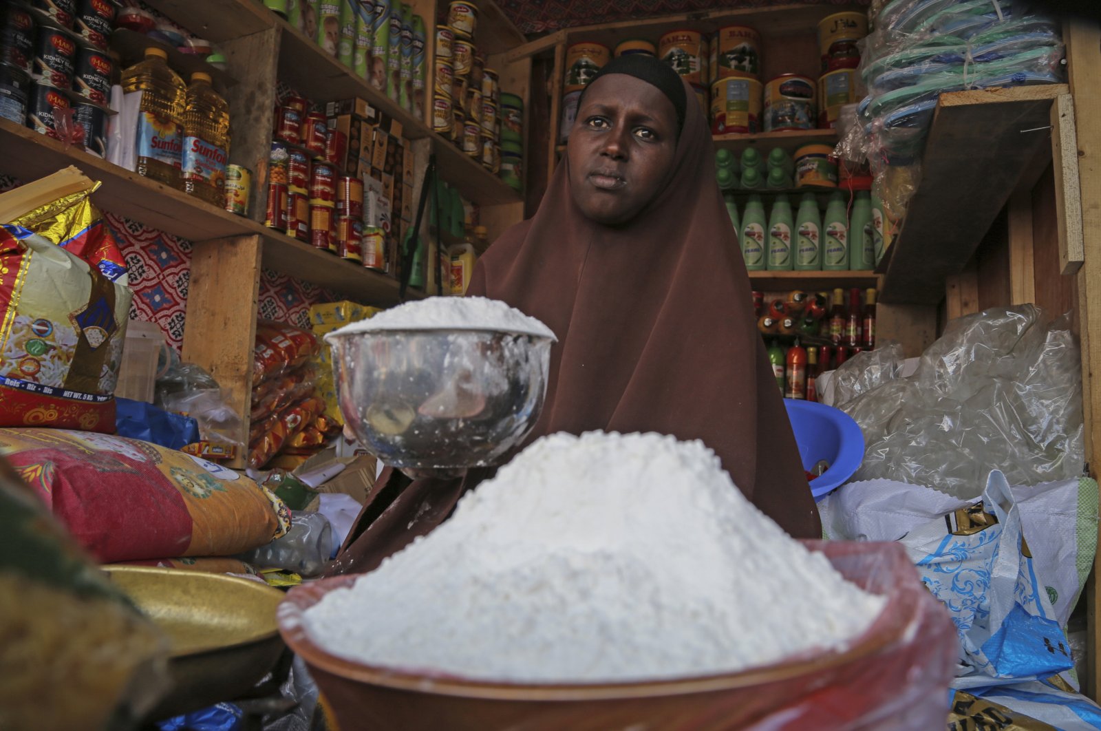 A shopkeeper sells wheat flour in the Hamar-Weyne market in the capital Mogadishu, Somalia, May 26, 2022. (AP Photo)