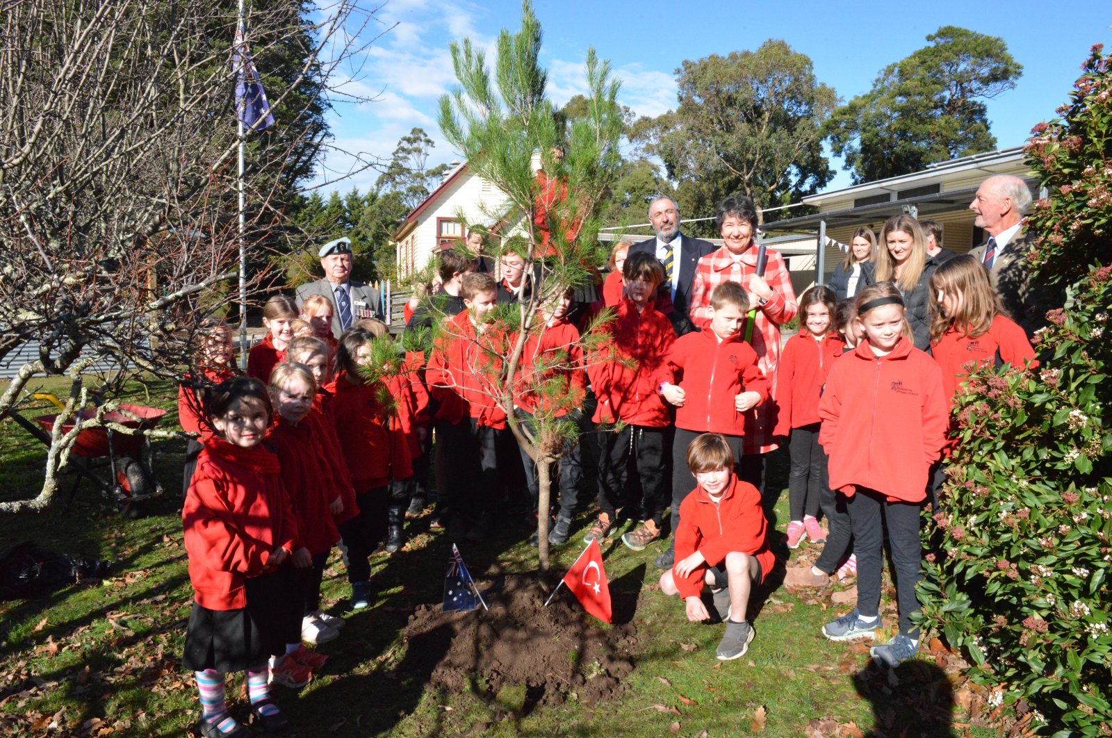 Students pose next to a tree they planted at Scotsburn primary school, in Victoria, Australia, June 20, 2022. (AA PHOTO)