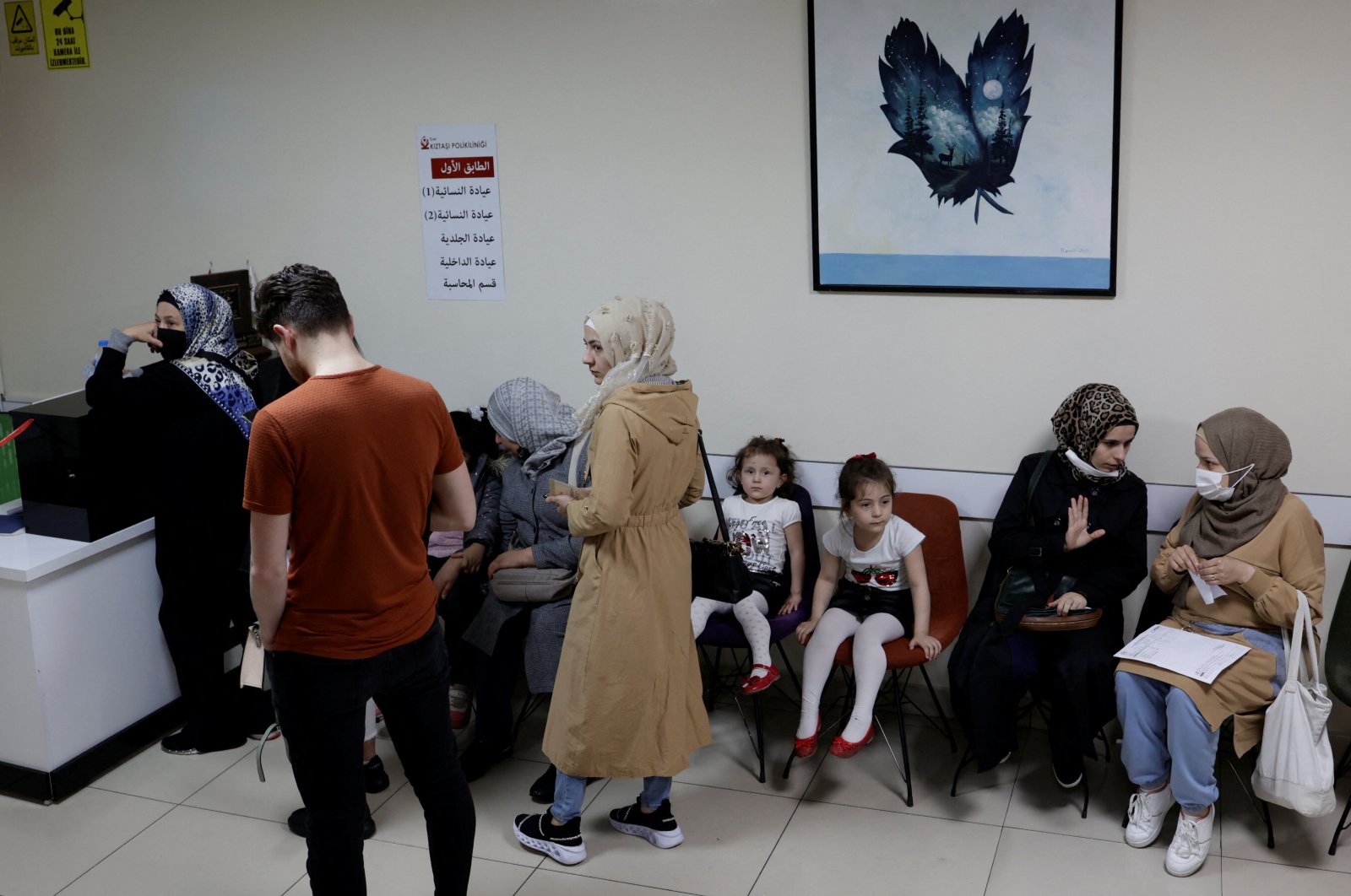 People, mostly Syrians living in Turkey, wait for their medical appointments at a clinic in Istanbul, Turkey, May 11, 2022. (REUTERS)
