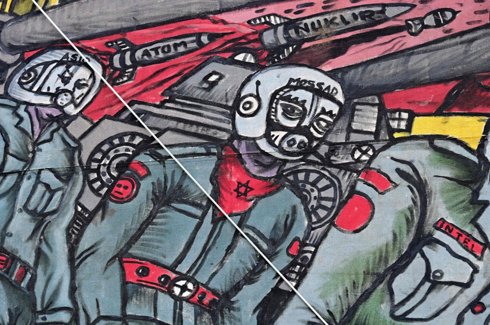A detail of the controversial large-scale figurative representation &quot;People&#039;s Justice&quot; (2002) by Taring Padi, a collective of underground artists from Indonesia, depicting a soldier with a pig&#039;s face wearing a scarf with a Star of David and a helmet with the inscription &quot;Mossad&quot; is pictured during the documenta fifteen contemporary art exhibition in Kassel, Germany, June 20, 2022. (AFP)