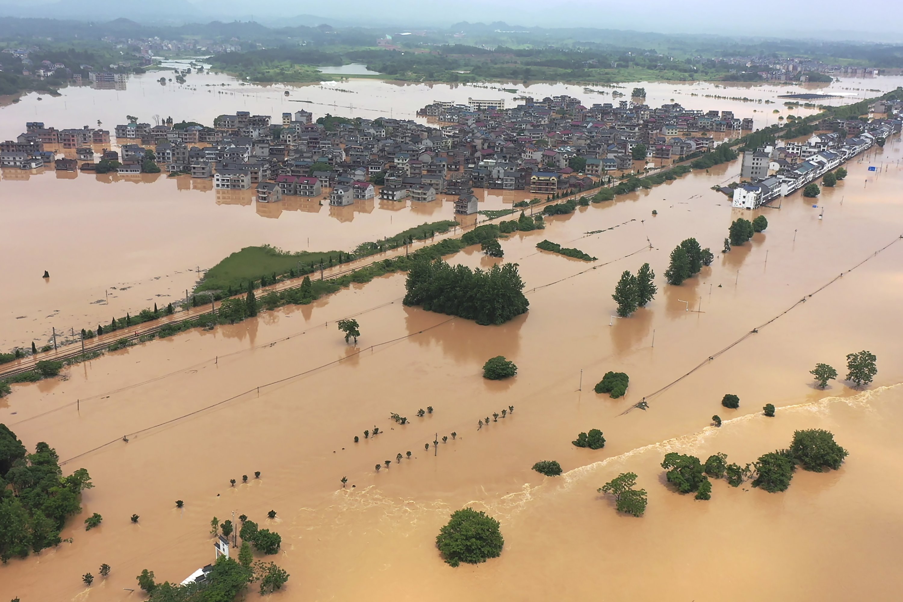 Floodwaters flow around a town in Shangrao, Jiangxi province, China, June 21, 2022. (AP Photo)