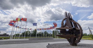 Flags of NATO member countries flap in the wind outside NATO headquarters, in Brussels, Belgium, May 25, 2022. (AP Photo)