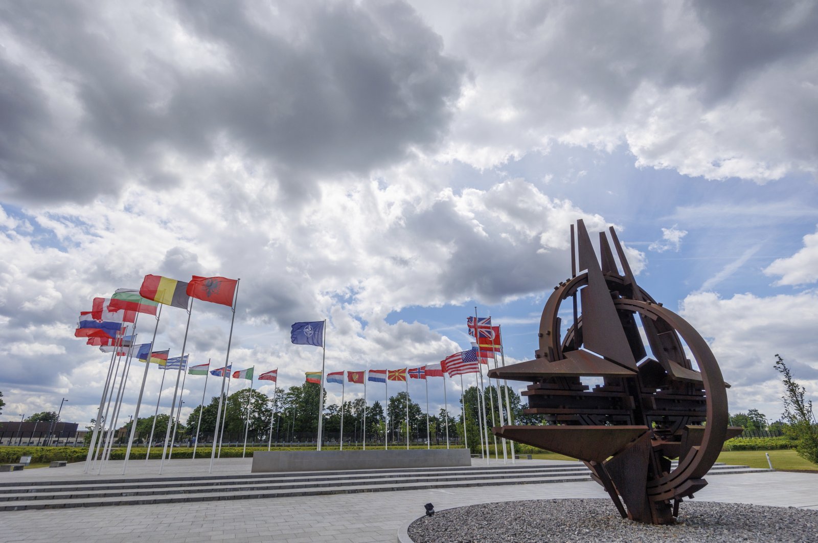 Flags of NATO member countries flap in the wind outside NATO headquarters, in Brussels, Belgium, May 25, 2022. (AP Photo)