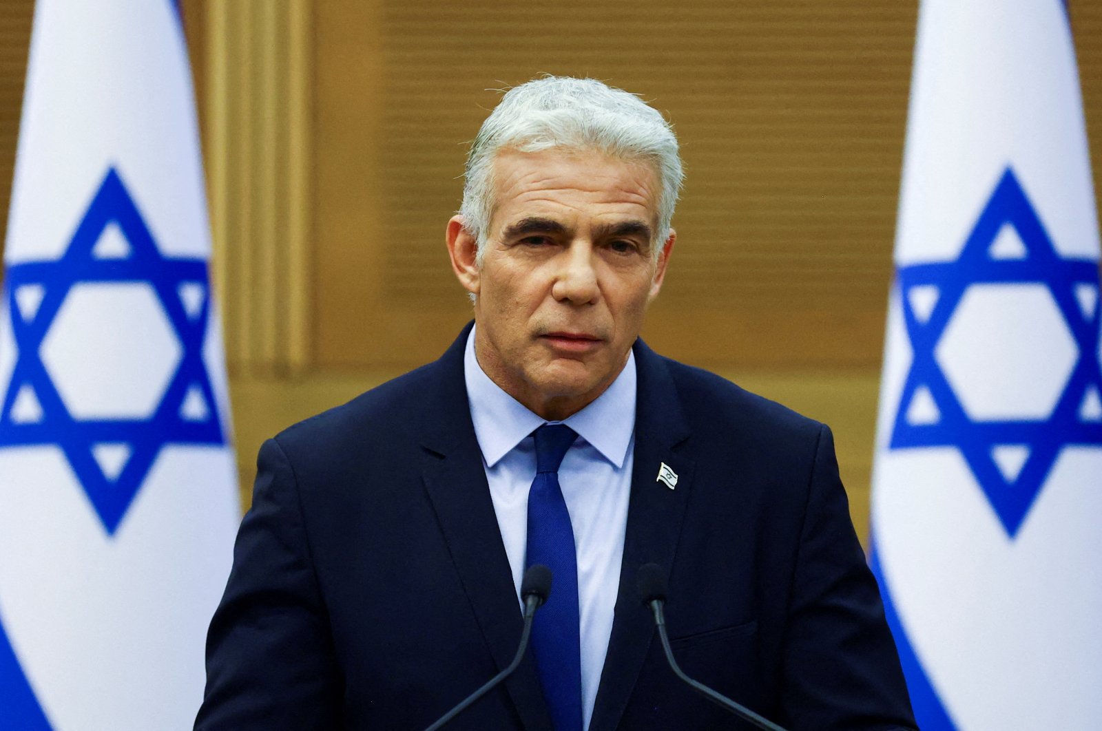Israeli Foreign Minister Yair Lapid speaks next to Prime Minister Naftali Bennett (not pictured) as they give a statement at the Knesset, Israel&#039;s parliament, in Jerusalem, June 20, 2022. REUTERS/Ronen Zvulun/File Photo