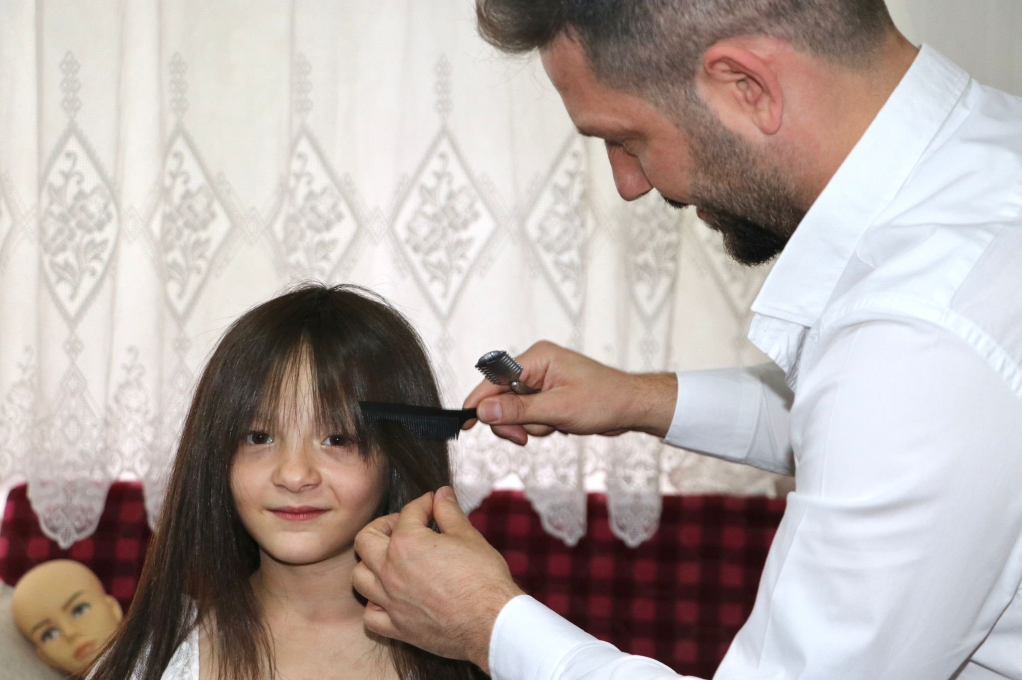 Yasin Kirazlı, 28, penata rambut yang tinggal di ibu kota Turki, Ankara, membantu mewujudkan gadis Suriah berusia 8 tahun, impian Hale Bereket dengan wig yang dibuatnya, Ankara, Turki, 22 Juni 2022. (Foto DHA)
