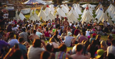 People attend the first day of the Glastonbury Festival at Worthy Farm in Somerset, England, June 22, 2022. (AP)
