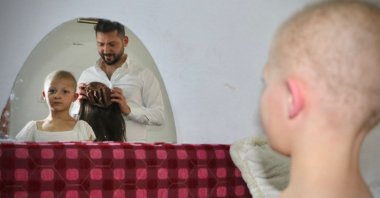 Yasin Kirazlı, 28, a hairdresser living in Turkey's capital Ankara helps in making an 8-year-old Syrian girl, Hale Bereket's dream come true with the wig he made, Ankara, Turkey, June 22, 2022. (DHA Photo)