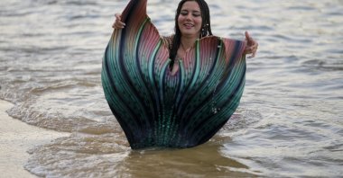 Lauren Metzler, founder of Sydney Mermaids, prepares for a swim at Manly Cove Beach in Sydney, Australia, May 26, 2022. (AP Photo)