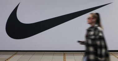 A woman walks past a closed store of the sporting goods retailer Nike at a shopping mall in Saint Petersburg, Russia, May 25, 2022. (Reuters Photo)