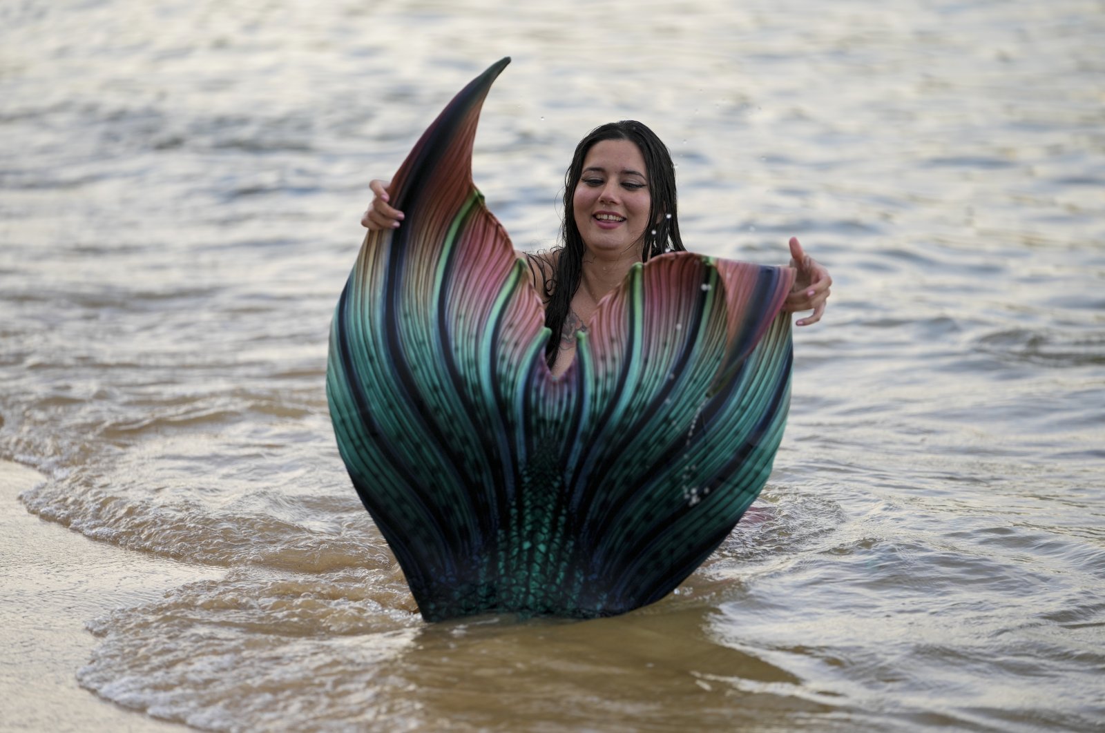 Lauren Metzler, founder of Sydney Mermaids, prepares for a swim at Manly Cove Beach in Sydney, Australia, May 26, 2022. (AP Photo)