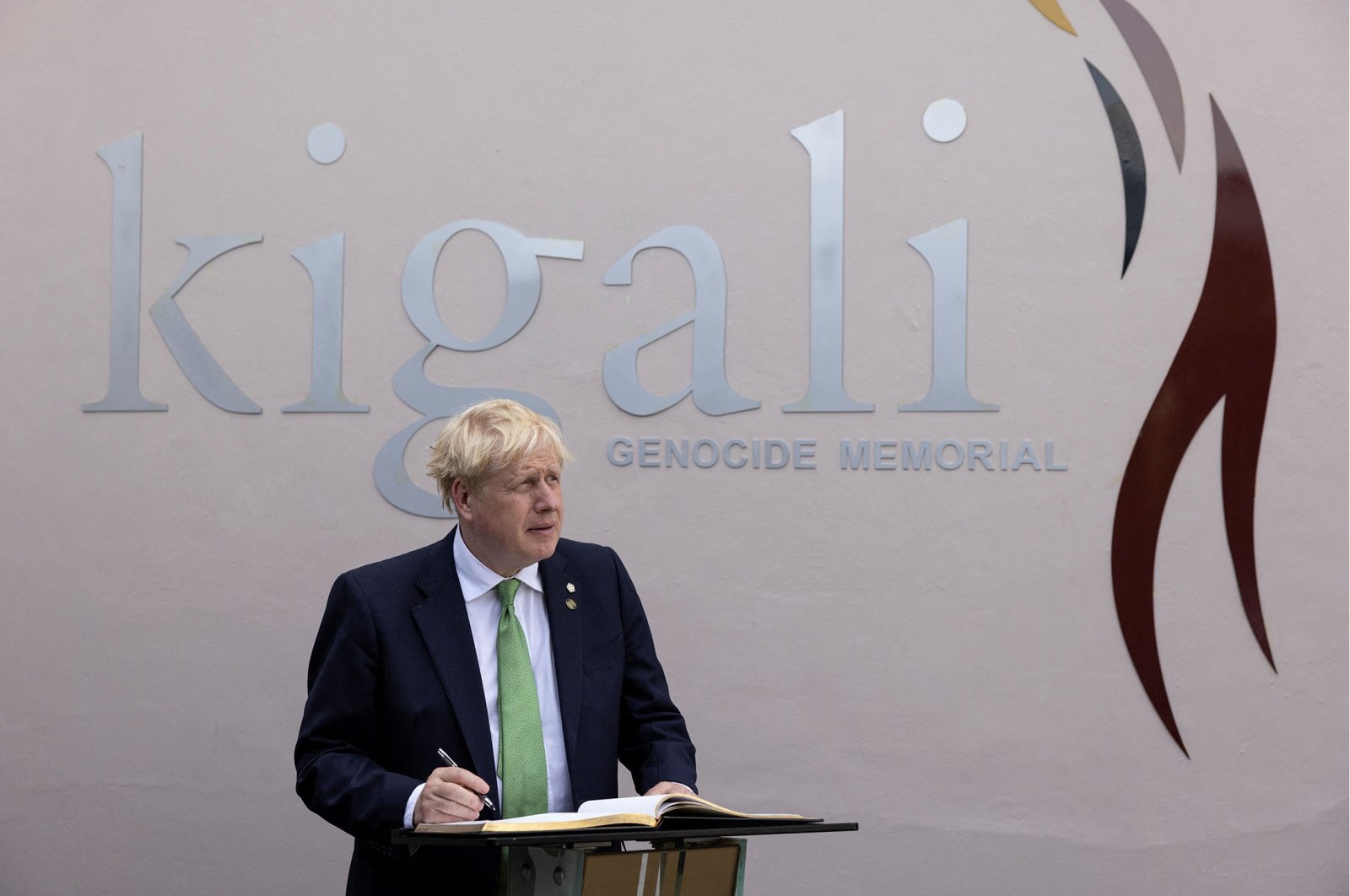 British Prime Minister Boris Johnson signs the visitors book while visiting the Kigali Genocide Memorial in Kigali, Rwanda, June 23, 2022. (Reuters Photo)