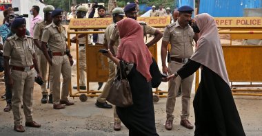 Indian Muslim women stand in front of police personnel during a protest over the hijab ban organized by a Muslim organization in Bengaluru, India, March 26, 2022. (EPA Photo)