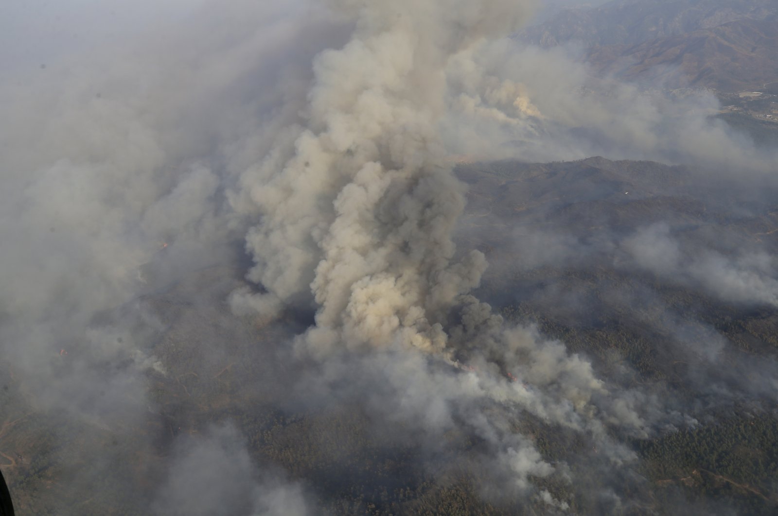 A view of smoke billowing from the burning forest, from a helicopter responding to the fire, in Marmaris, Muğla, southwestern Turkey, June 24, 2022. (AA PHOTO)