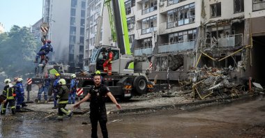 Rescue workers work at an apartment building destroyed in a missile strike, amid Russia's invasion of Ukraine, in Kyiv, Ukraine, June 26, 2022. (Reuters Photo)