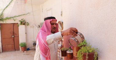 Torture victim Ismail Mustafa waters his plants in his home in Tal Abyad, Syria, June 26, 2022. (AA Photo)