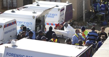 A body is removed from a nightclub in East London, South Africa, June 26, 2022. (AP Photo)