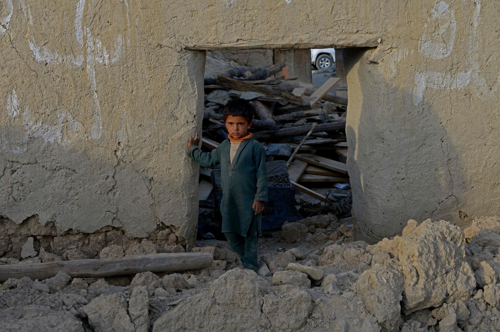 A boy stands inside a damaged house after a recent earthquake at Akhtar Jan village in Gayan district of Paktika province, Afghanistan, June 25, 2022. (AFP Photo)