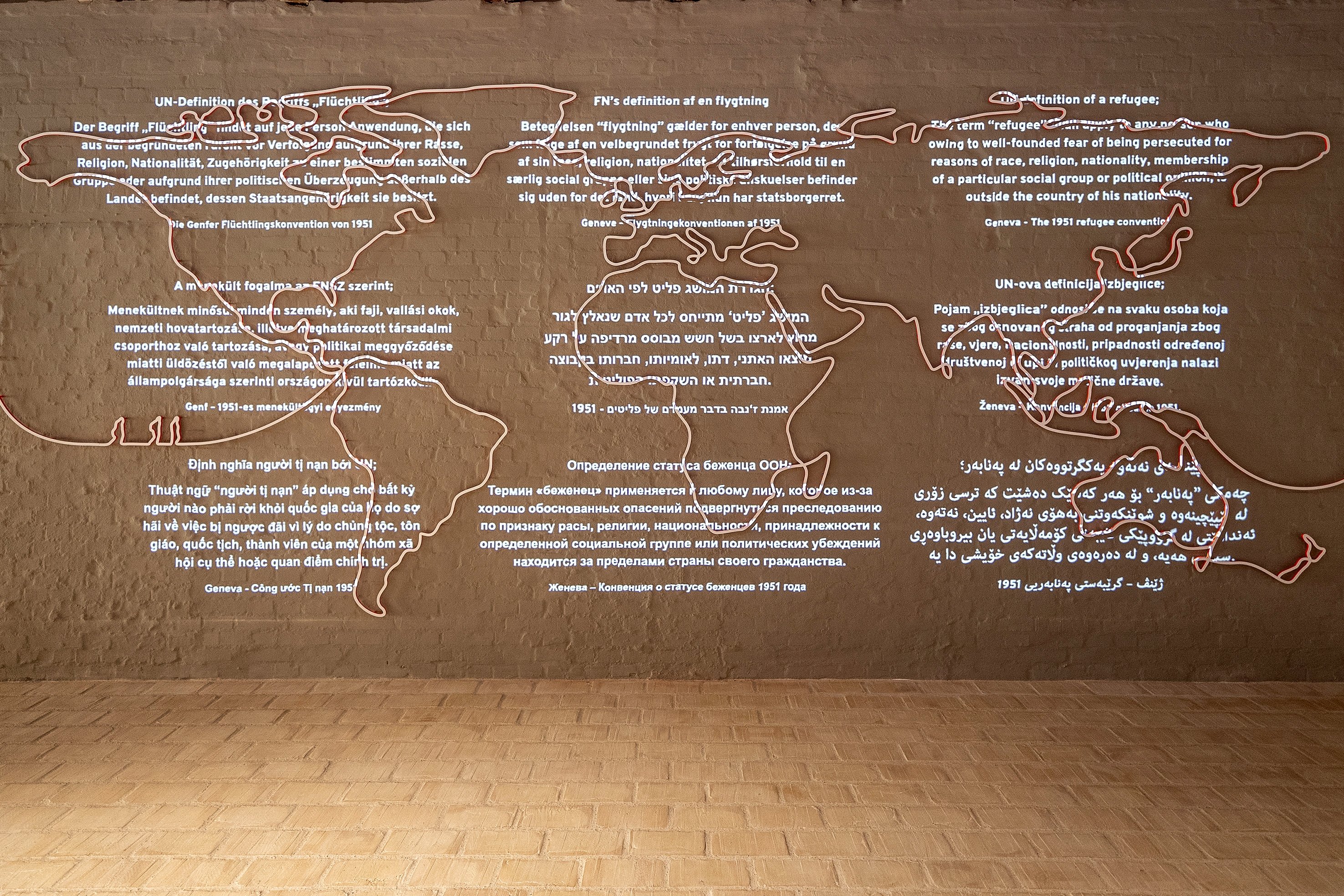 Information on a wall, in Flugt, a new museum for refugee stories, in Oksboel, Denmark, June 24, 2022. (AP Photo)