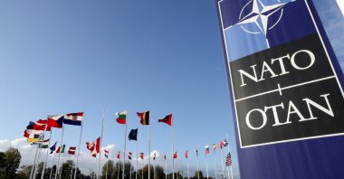 Flags wave outside the Alliance headquarters ahead of a NATO Defence Ministers meeting, in Brussels, Belgium, October 21, 2021. (Reuters)