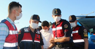 Gendarmerie officers escort C.M.A. in Muğla, southwestern Turkey, July 21, 2020 (IHA Photo)