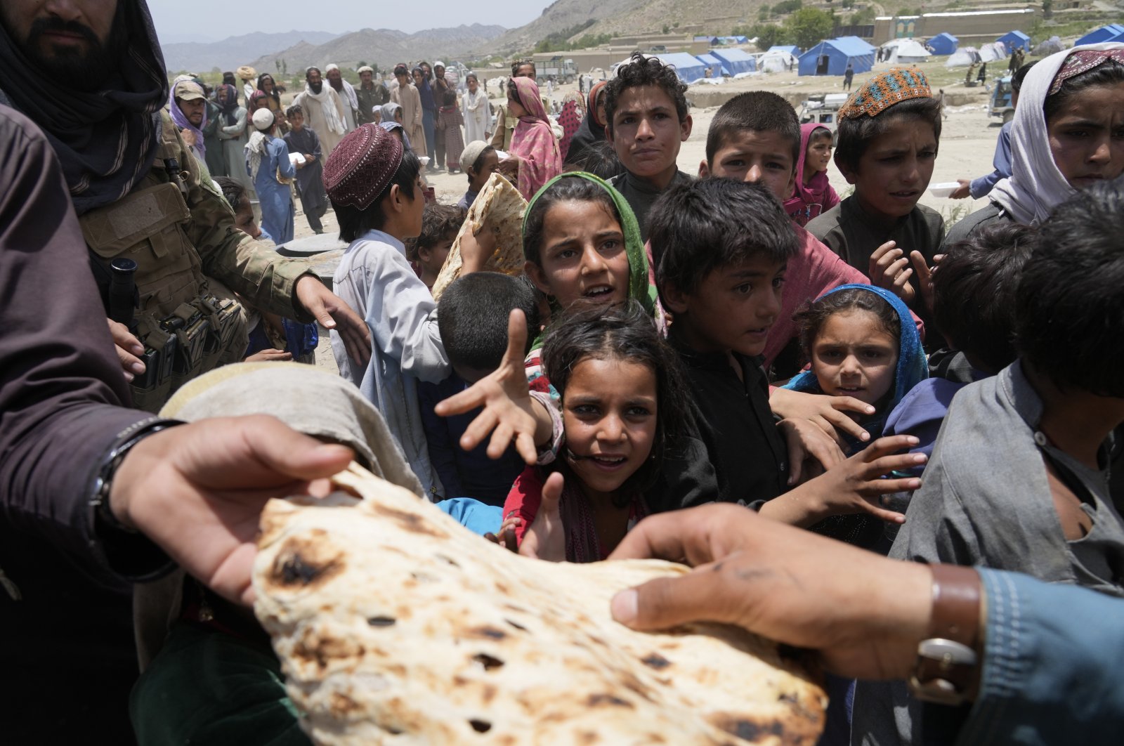 Afghans receive aid at a camp after an earthquake in the Gayan district of Paktika province, Afghanistan, June 26, 2022. (AP Photo)