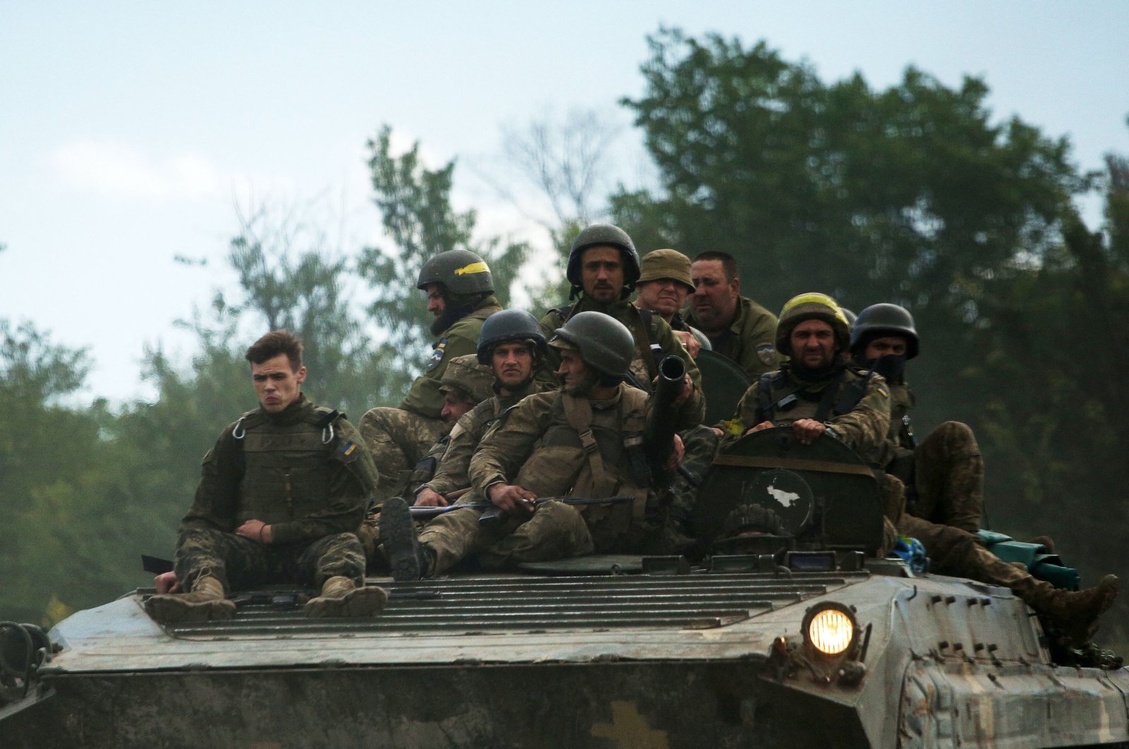 Ukrainian soldiers ride on an armored personnel carrier (APC) on a road of the eastern Luhansk region, Ukraine, June 23, 2022. (AFP Photo)