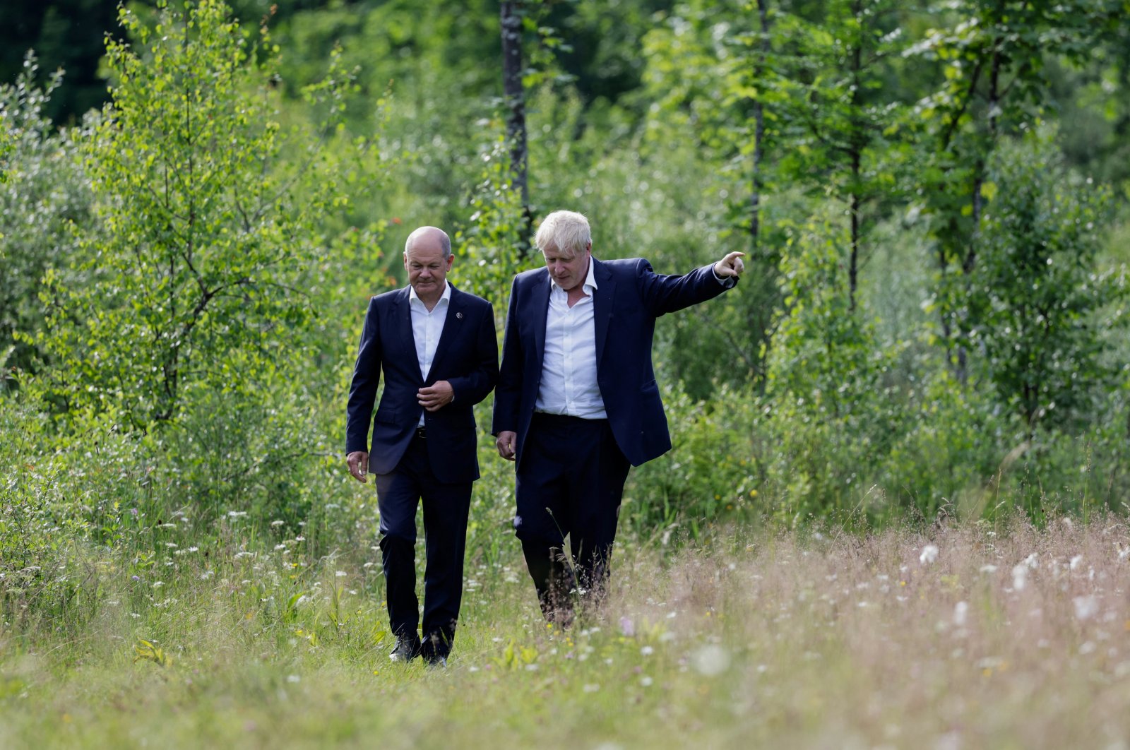 German Chancellor Olaf Scholz (L) and British Prime Minister Boris Johnson walk during a bilateral meeting at Schloss Elmau Castle at the G-7 leader summit in the Bavarian Alps near Garmisch-Partenkirchen, Germany, June 26, 2022. (Reuters Photo)