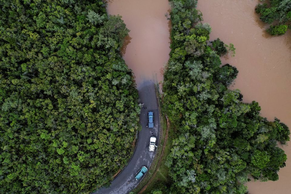 Cars stop before a flooded area after Cyclone Batsirai made landfall on a road in Vohiparara, Madagascar, Feb. 6, 2022. (Reuters Photo)