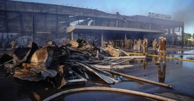 Rescuers and service members work at a site of a shopping mall hit by a Russian missile strike in Kremenchuk, the Poltava region, Ukraine, June 27, 2022. (Reuters Photo)