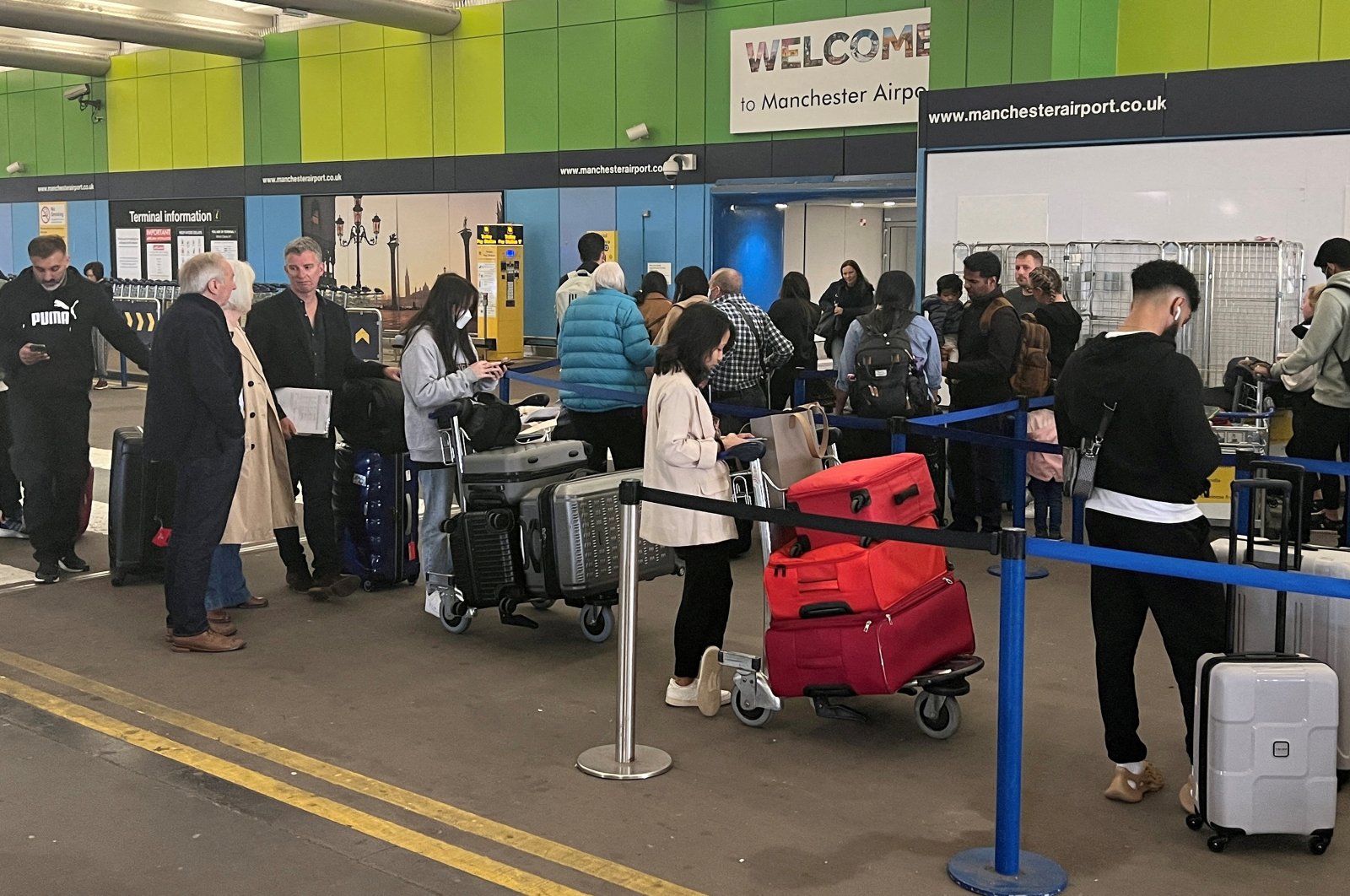 Passengers queue outside Terminal 1 at Manchester Airport, Manchester, U.K., June 1, 2022. (Reuters File Photo)