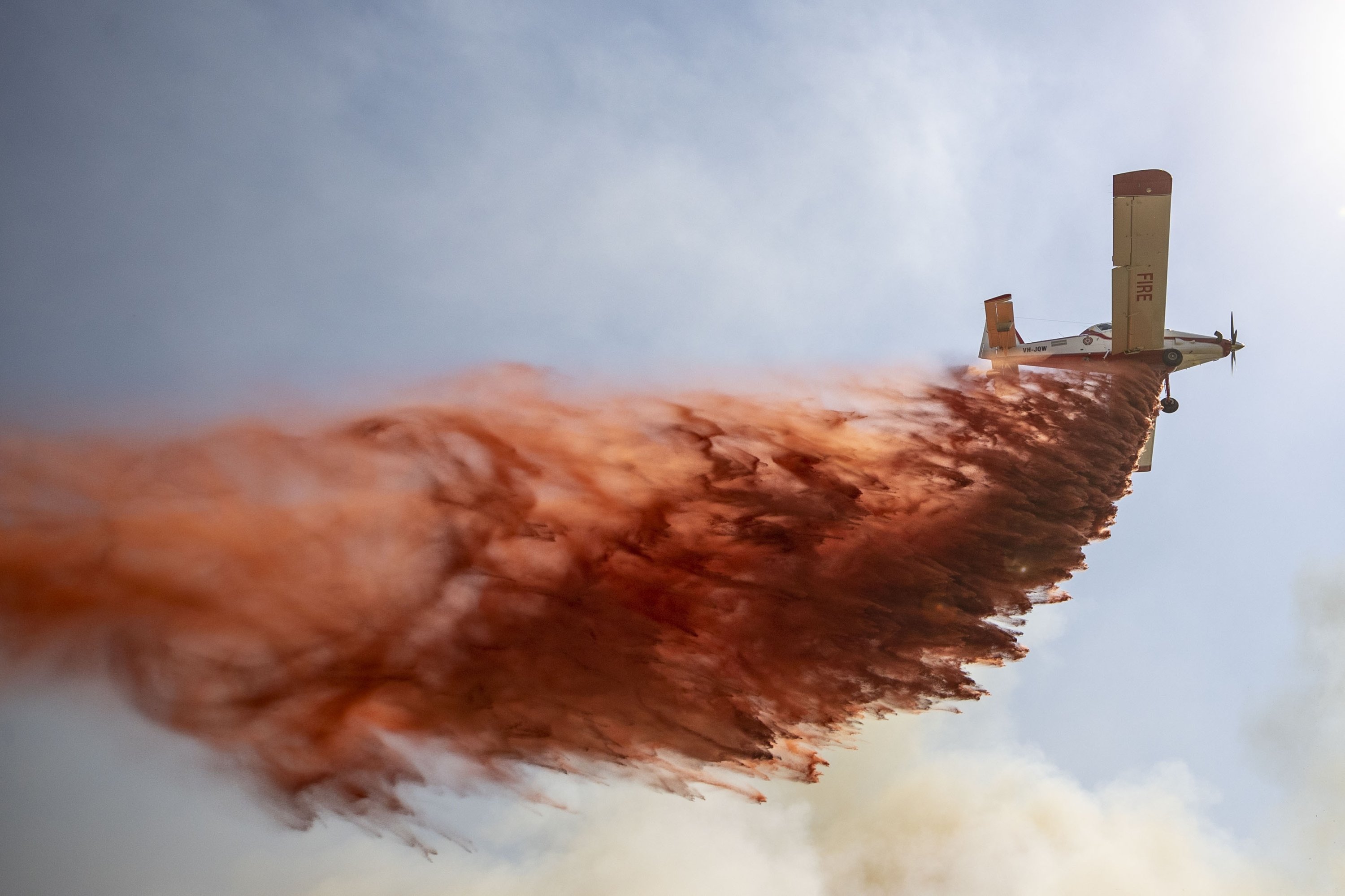 A helicopter pours fire-retardant on burning areas in Marmaris, Muğla, southwestern Turkey, June 22, 2022. (AA PHOTO)