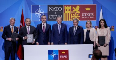 From left to right, Finnish Foreign Minister Pekka Haavisto, Turkish Foreign Minister Mevlüt Çavuşoğlu, NATO Secretary-General Jens Stoltenberg, Turkish President Recep Tayyip Erdoğan, Finland's President Sauli Niinisto, Sweden's Prime Minister Magdalena Andersson and Sweden's Foreign Minister Ann Linde pose for a picture after signing a memorandum in which Turkey agrees to Finland and Sweden's membership of the defense alliance in Madrid, Spain, June 28, 2022. (AP Photo)