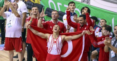 Gymnast Adem Asil (C) celebrates with teammates after winning all-around gold at the Mediterranean Games, Oran, Algeria, June 28, 2022. (AA Photo)