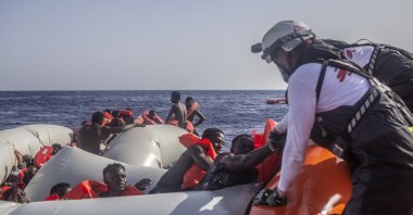 In this photo released by Doctors Without Borders (MSF) and taken on June 27, the MSF team rescues 71 people from a rubber boat in distress, Mediterranean Sea, June 29, 2022. (MSF via AP)