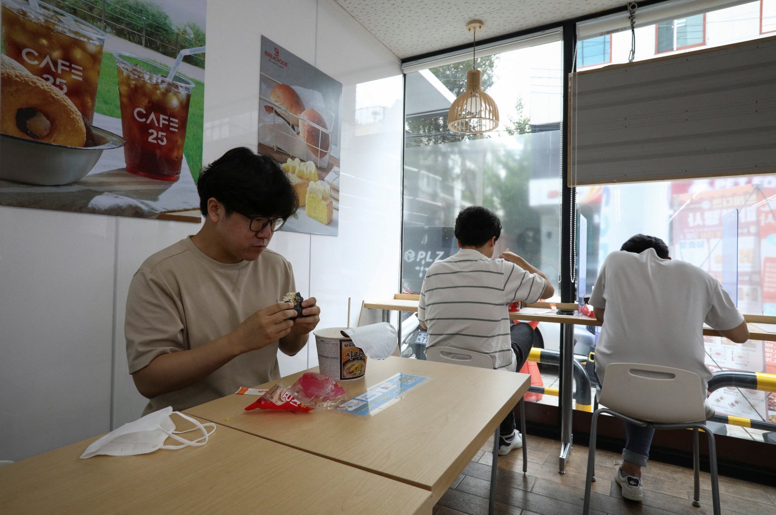 An office worker eats lunch at a convenience store in Seoul, South Korea, June 24, 2022. (Reuters Photo)