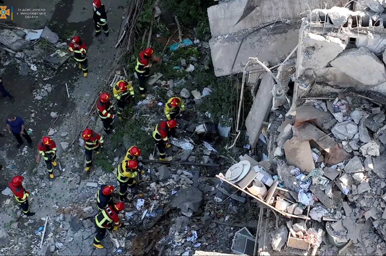 Rescuers work at a residential building hit by a Russian military strike in this screen grab obtained from a handout video, Mykolaiv, Ukraine, June 29, 2022. (State Emergency Service of Ukraine via Reuters)