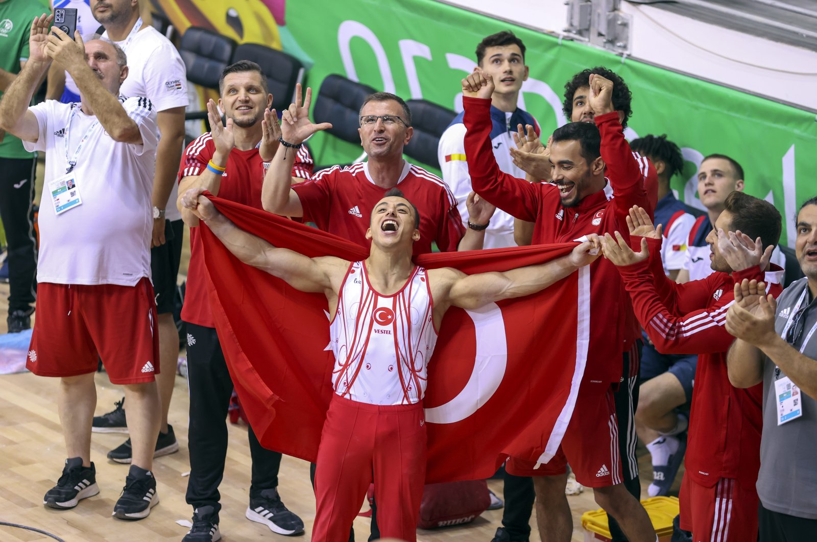 Gymnast Adem Asil (C) celebrates with teammates after winning all-around gold at the Mediterranean Games, Oran, Algeria, June 28, 2022. (AA Photo)