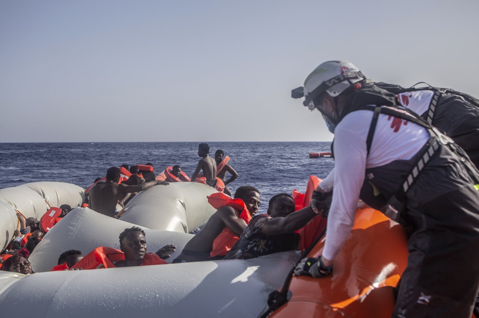 In this photo released by Doctors Without Borders (MSF) and taken on June 27, the MSF team rescues 71 people from a rubber boat in distress, Mediterranean Sea, June 29, 2022. (MSF via AP)