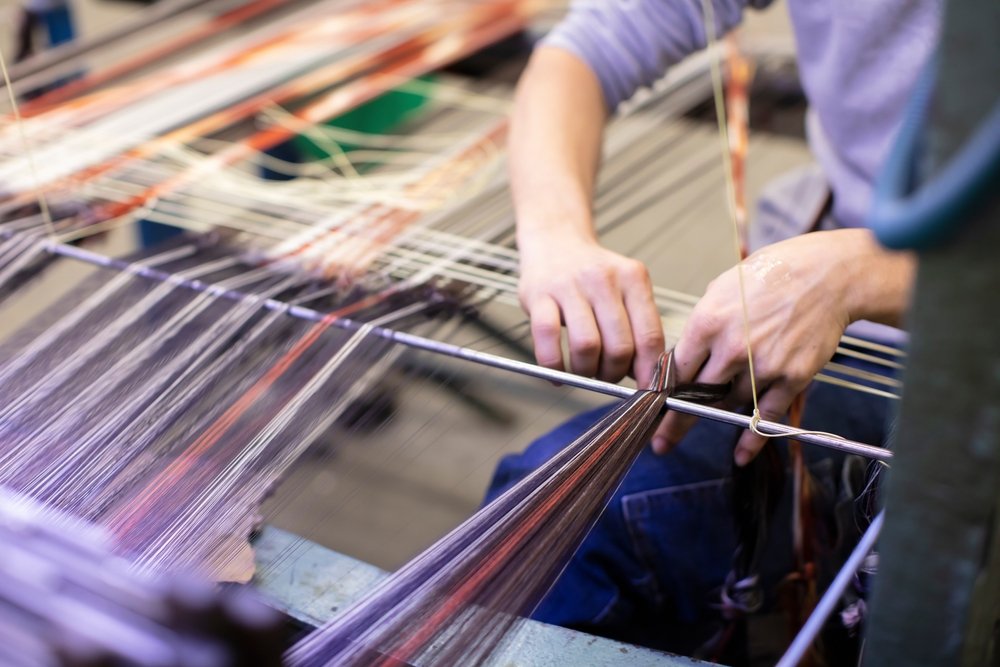Pria yang mengerjakan tenun untuk kain kutnu buatan tangan.  (Foto Shutterstock)
