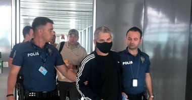 Police officers accompany Memet Gezer, in Istanbul, Turkey, June 30, 2022. (DHA PHOTO)