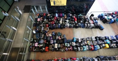 Lines of passenger luggage lie arranged outside Terminal 2 at Heathrow Airport in London, Britain, June 19, 2022. (Reuters Photo)