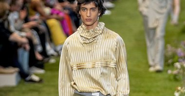 A model wears a yellow top piece is made by kutnu fabric, Paris, France, June 24, 2022. (AP Photo)